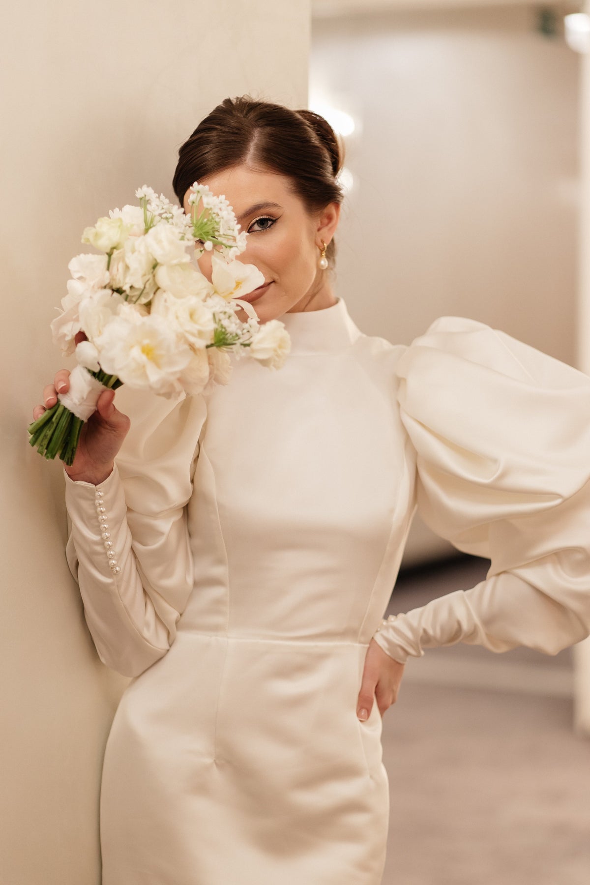 Ivory matte satin mini wedding dress with puff sleeves, side view