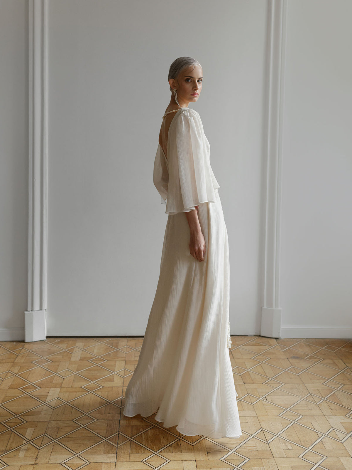 Close-up of the long sleeve fabric and cuff on the crash-chiffon wedding dress.