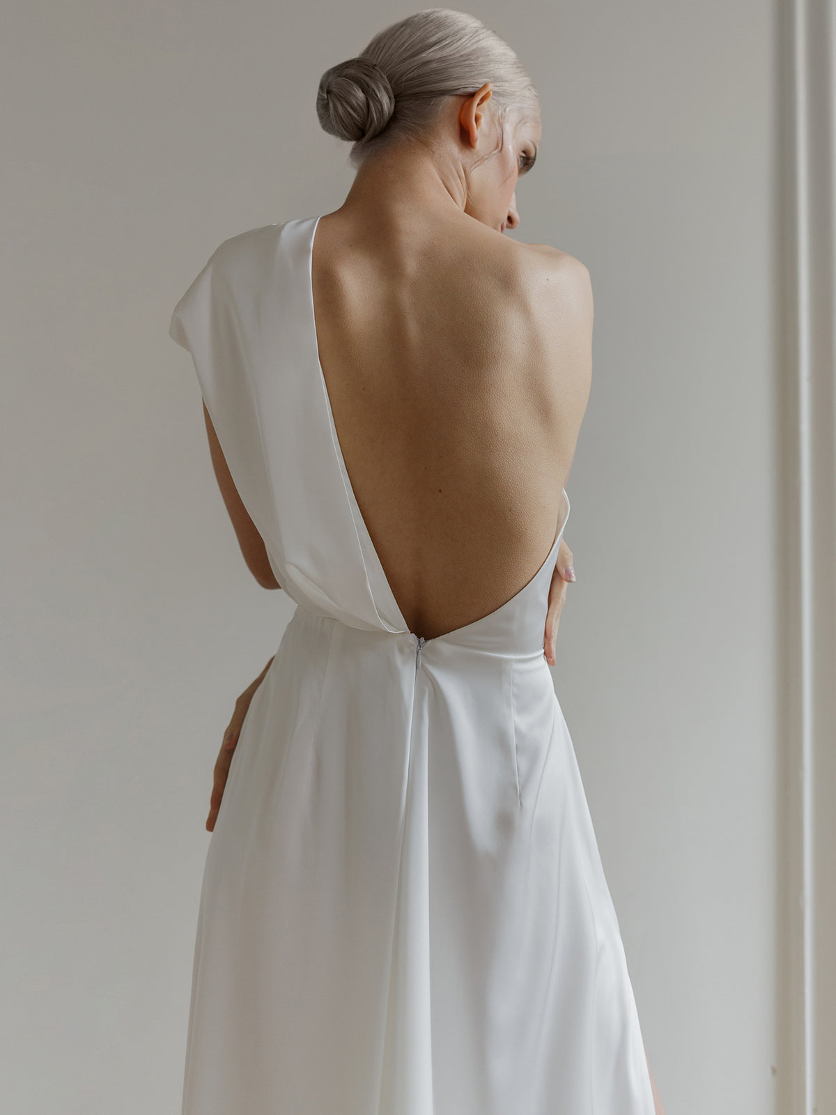 Nika wedding dress open back and one-shoulder drape, close-up