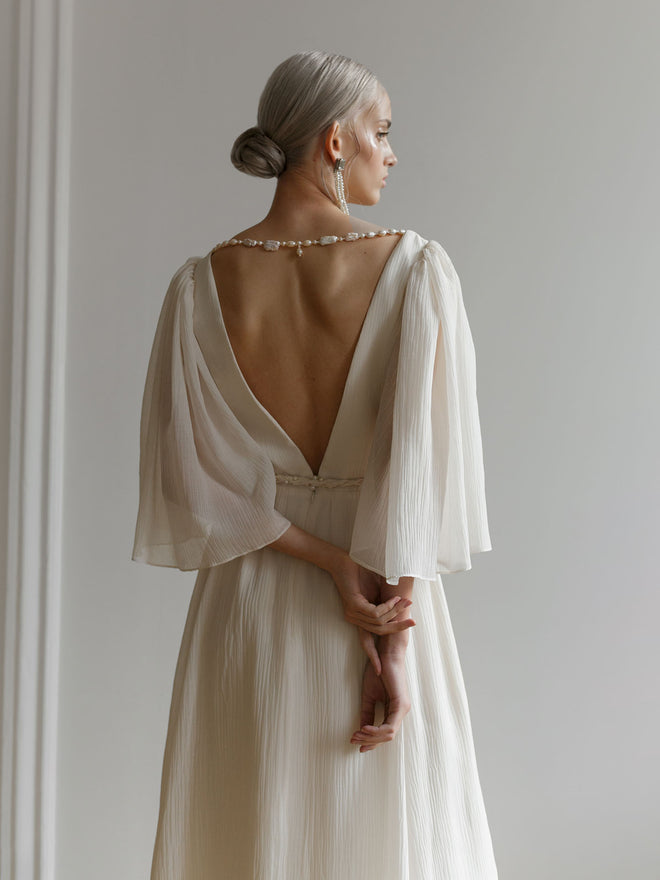 Back view of the ivory crash-chiffon wedding dress showing an open V-back neckline.