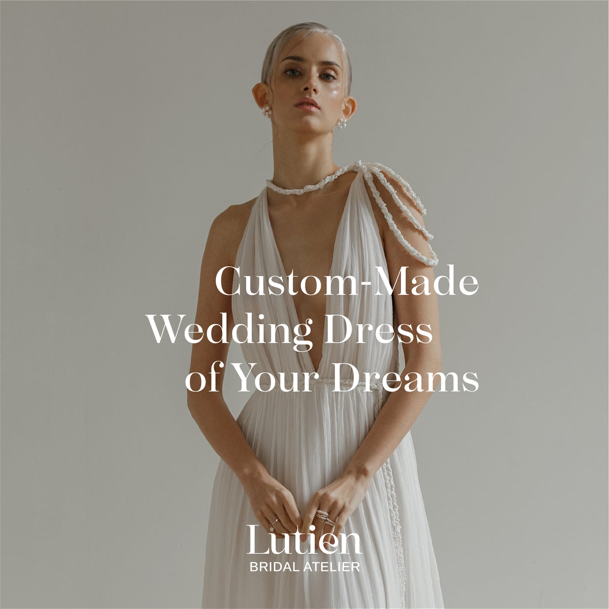 Lutien Bridal custom wedding dress in ivory with a fitted bodice and flowing skirt, the atelier's main product image.