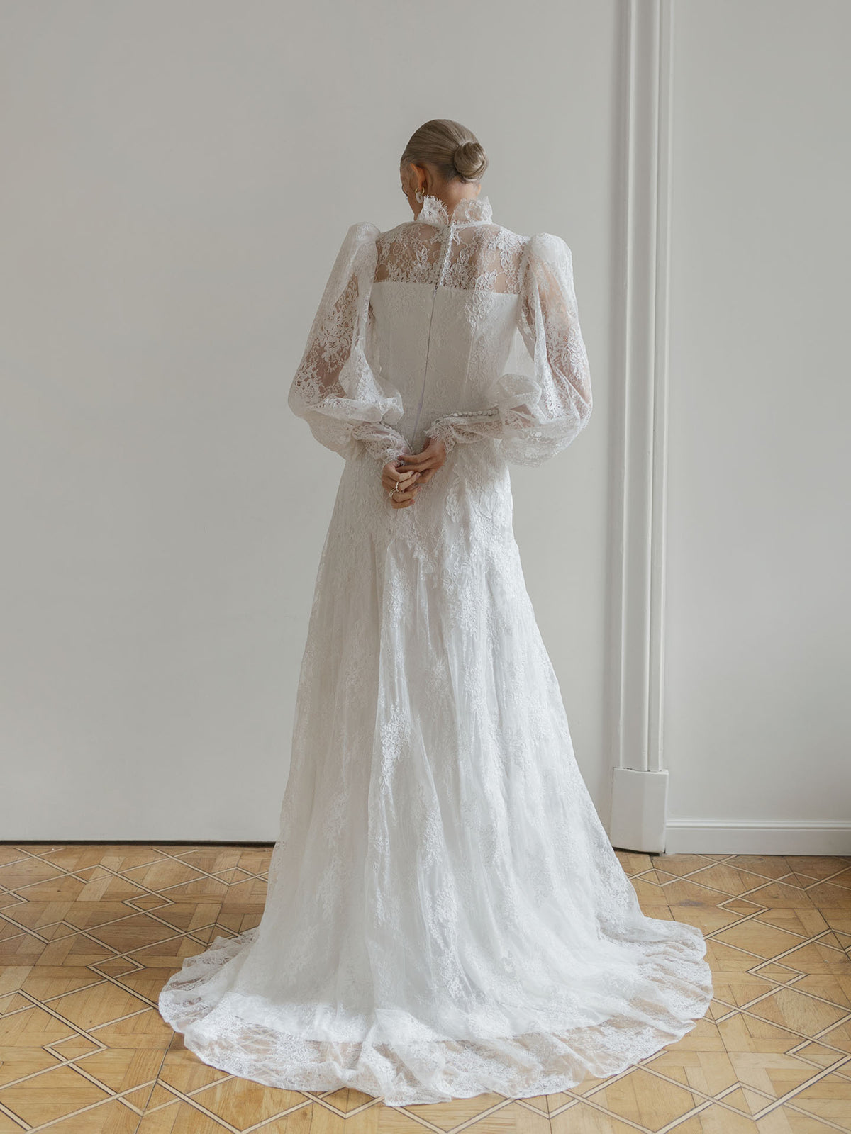 Close-up of the closed lace back panel on the high-neck wedding dress.