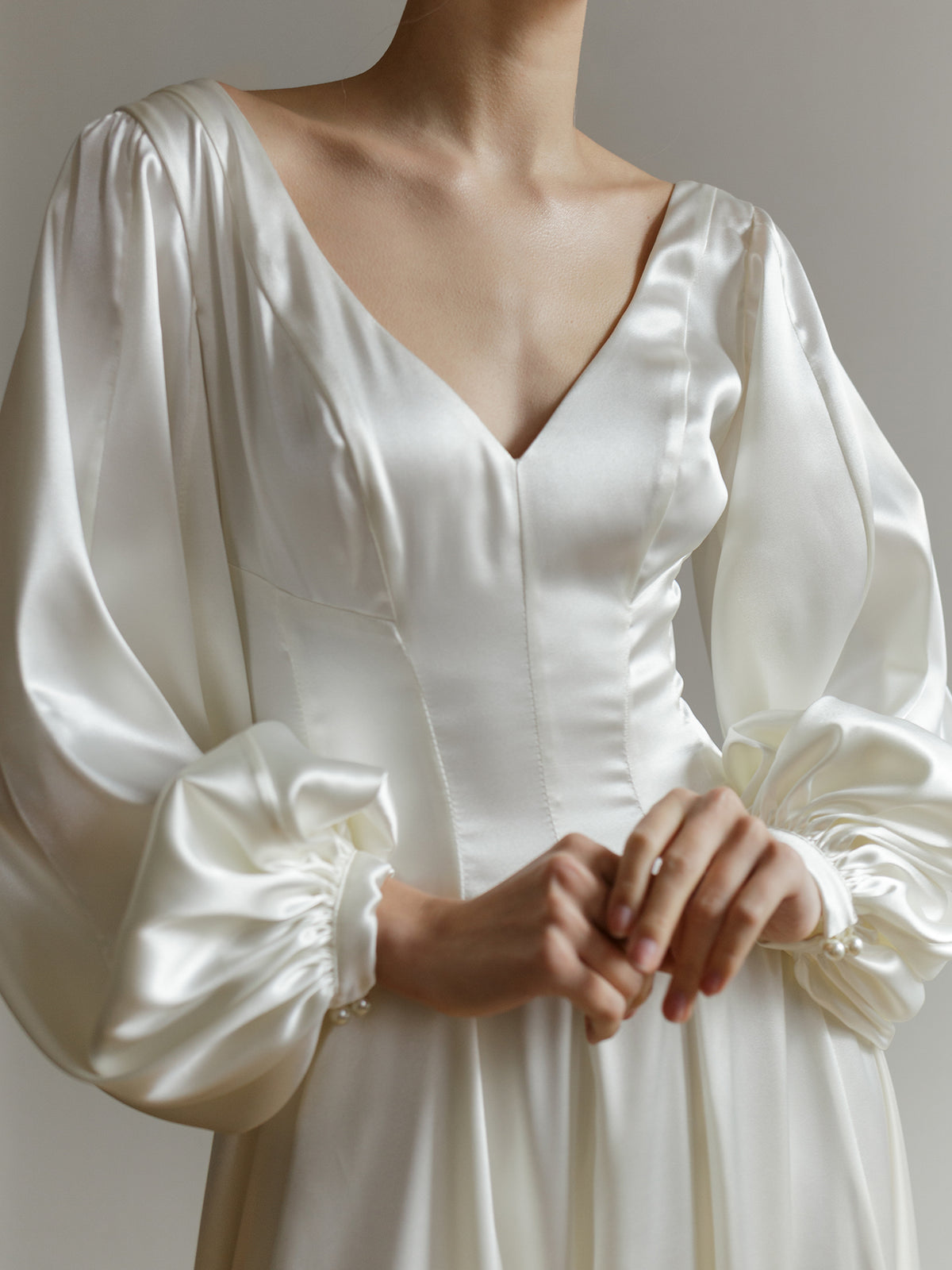 Front view of the satin wedding dress showing its clean, minimal silhouette.