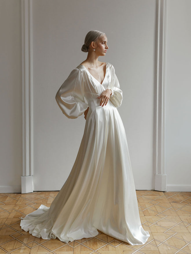 Lutien Bridal custom wedding dress in satin with a V-neckline and A-line skirt.
